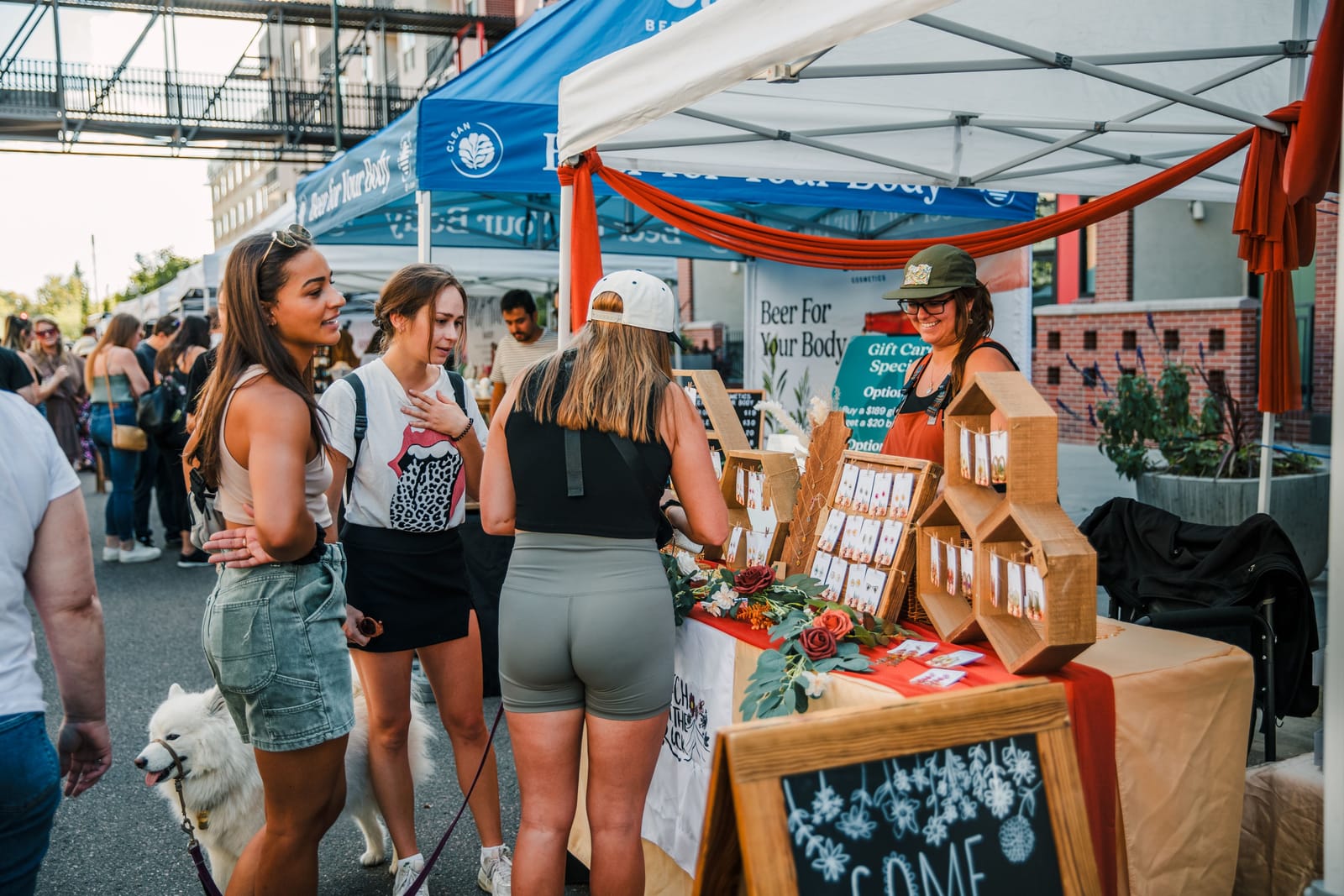 People gathering among local maker tents at a Denver BAZAAR event